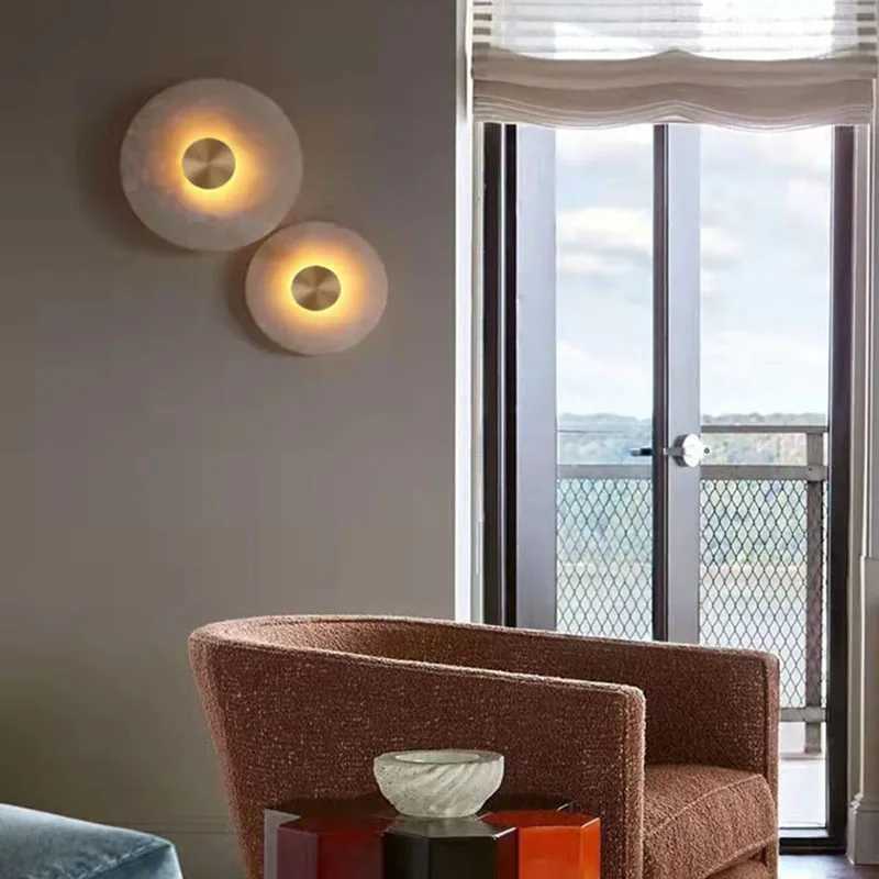 Art Deco-inspired round LED wall sconce with natural marble and brass accents, ideal for parlor, corridor, or aisle lighting to create atmospheric decor