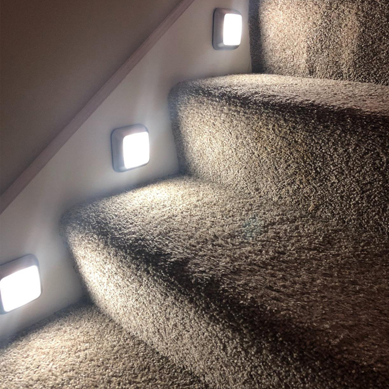 Battery-powered LED motion sensor night lights for cabinets, stairs, and walls