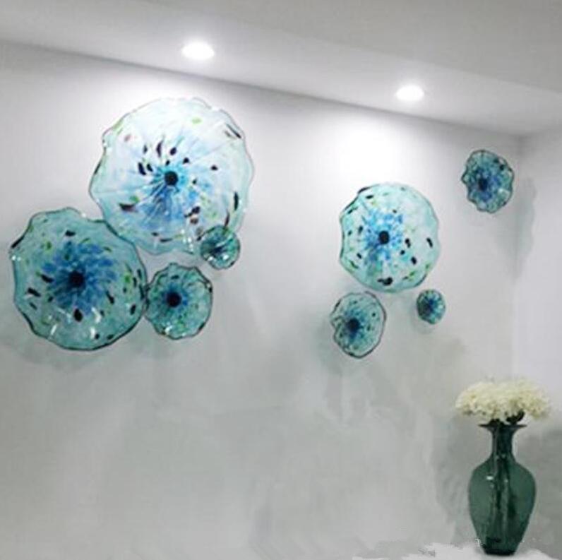 Elegant hand-blown Murano glass wall lamps in blue, featuring scalloped edges and floral art designs for a luxurious touch