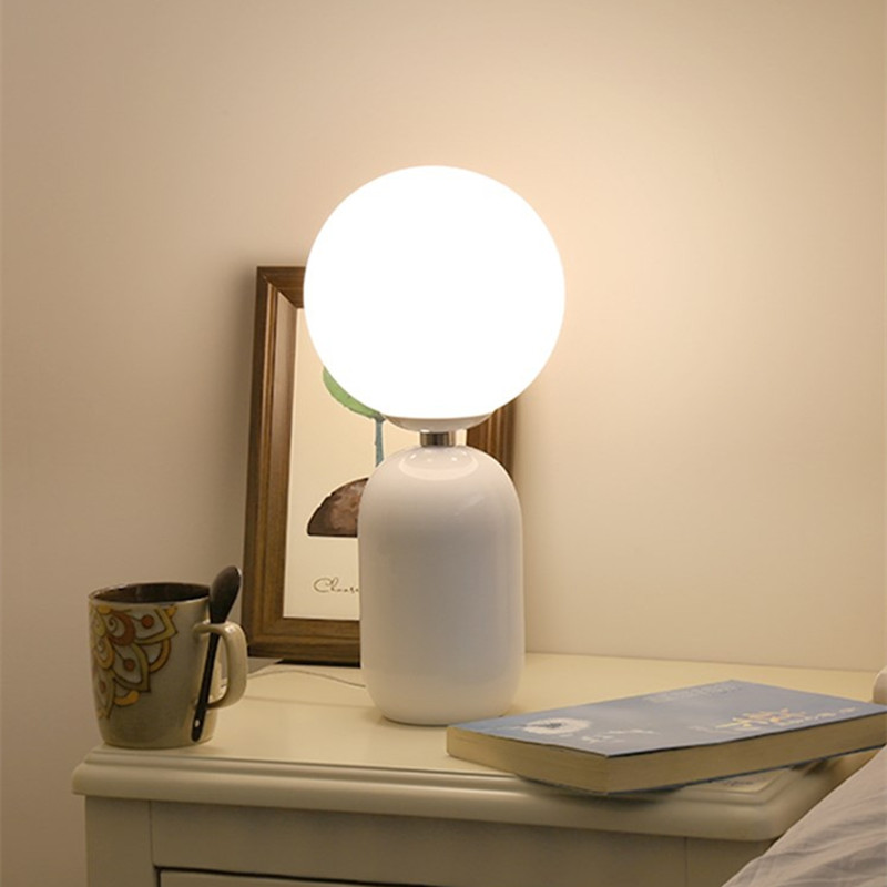 Elegant modern bedside lamp with glass ball design for versatile interiors