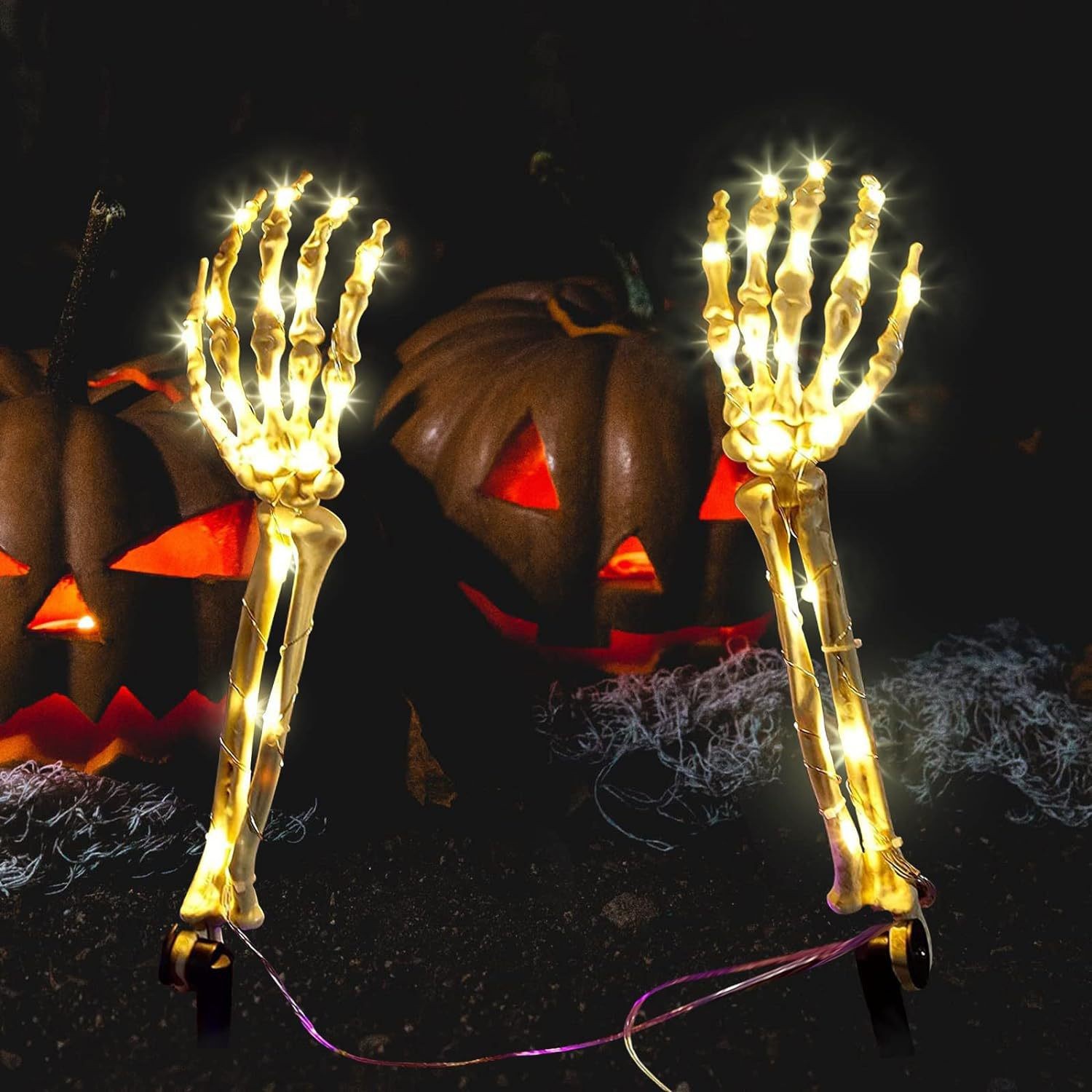 Halloween LED pathway stakes featuring skeletal hands with multiple lighting options and durable plastic construction