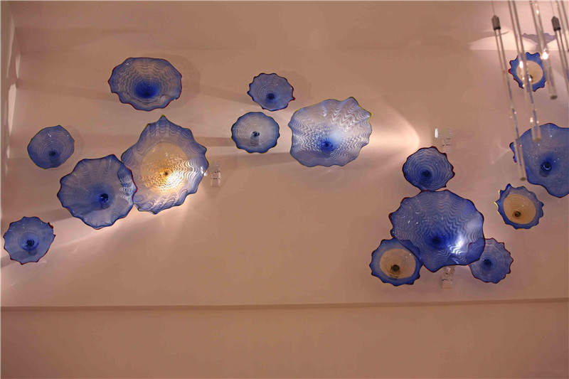 Handcrafted blue wall lamp featuring floral art and mouth-blown Murano glass plates, ideal for fireplace, stair, or ceiling decoration