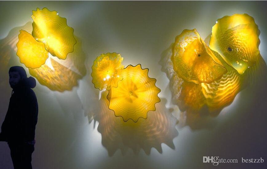Handcrafted lemon-yellow glass wall plate, also serves as an elegant table platter