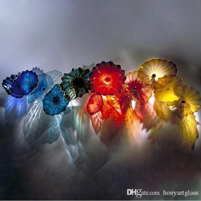 Handcrafted Murano glass wall plates in vibrant yellow and blue hues, perfect for illuminating hotel, villa, or fireplace decor