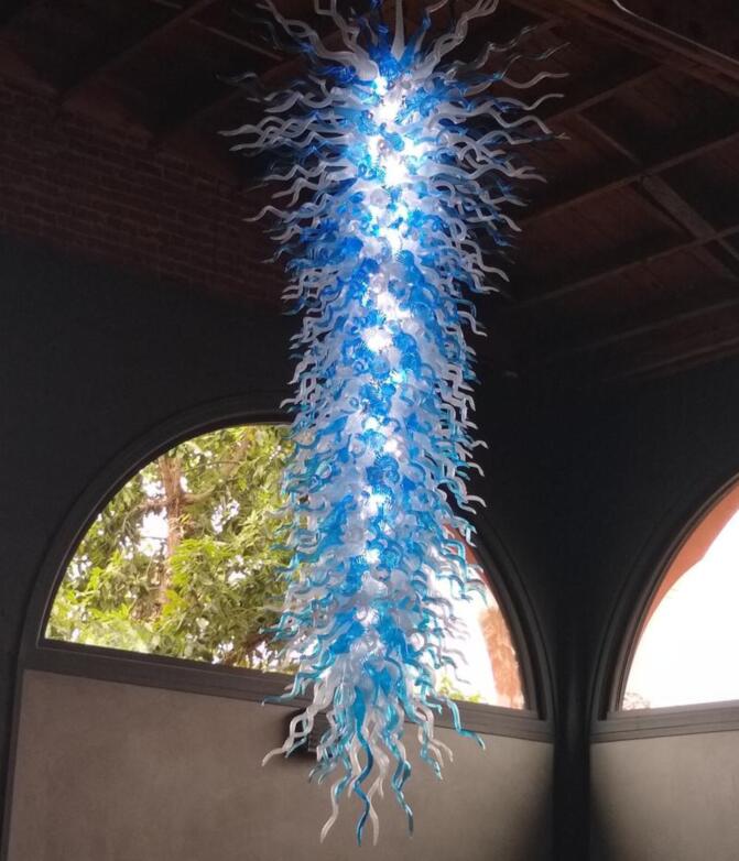 Large decorative LED chandeliers with hand-blown blue and white glass, designed for high ceilings and hung with chains