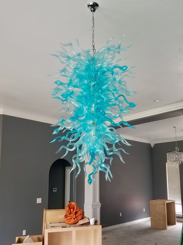 Large handcrafted turquoise glass chandelier with LED lighting, featuring long chain pendants ideal for Christmas decor