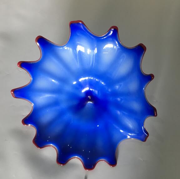 Mediterranean-style modern wall art featuring hand-blown Murano glass flowers and decorative hanging plates for home decor