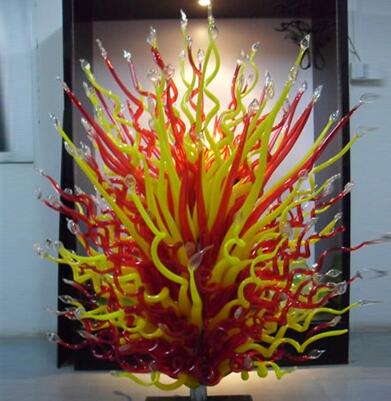 Modern handcrafted blown glass floor lamps featuring red and yellow hues, perfect as garden art or decorative Murano glass sculptures