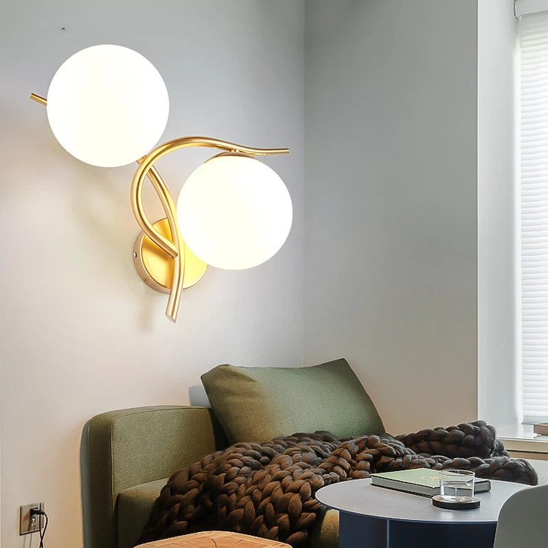 Modern minimalist iron-framed LED wall lamp with glass sphere accents, perfect for loft-style bedroom or living room decor