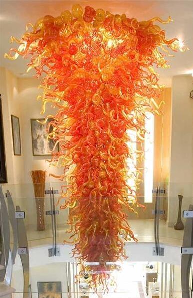 Modern oversized orange chandeliers featuring hand-blown glass for luxurious decorative lighting