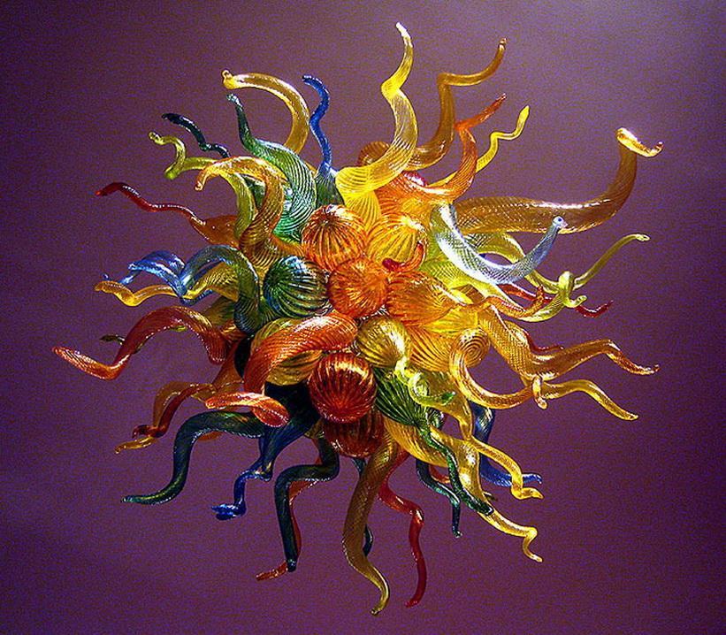 Multi-colored blown glass chandelier with golden accents, a modern Chihuly-inspired lighting fixture for stylish home interiors