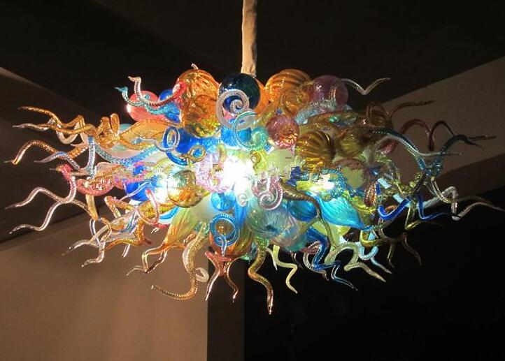 Multi-colored contemporary chandeliers featuring LED illumination, crafted with Tiffany-style stained glass and hand-blown artistry, suspended elegantly on chains for decorative lighting