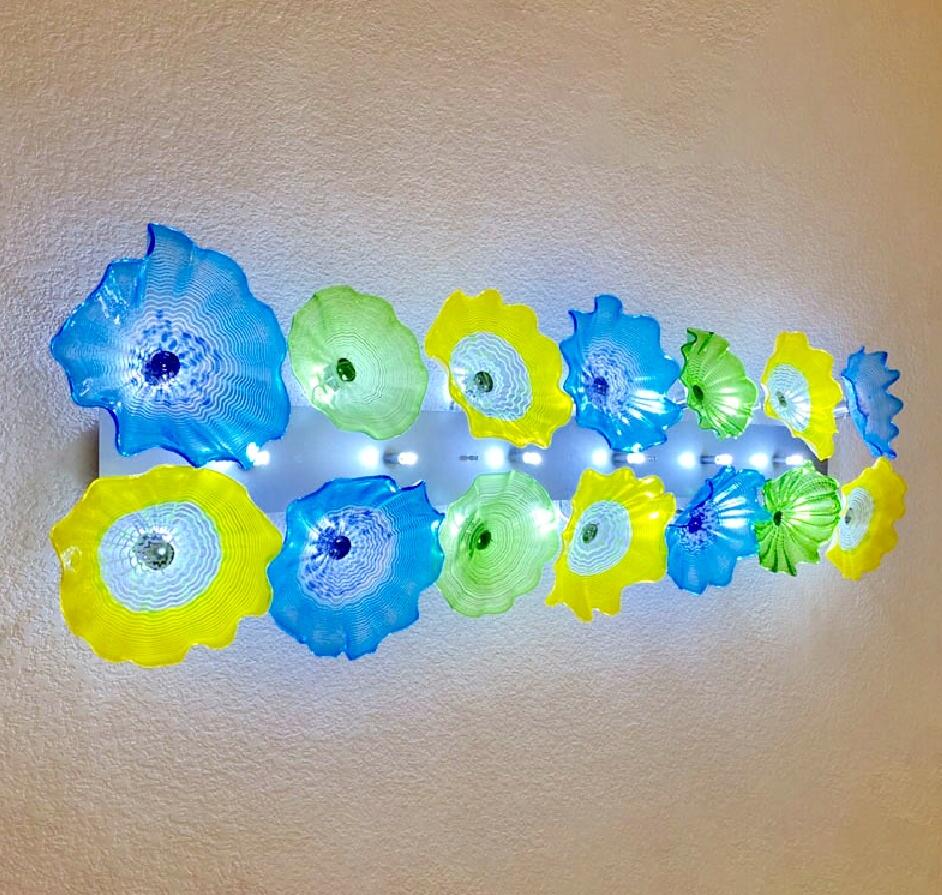 Multi-colored Italian LED wall sconce featuring hand-blown Murano glass art in a floral plate design