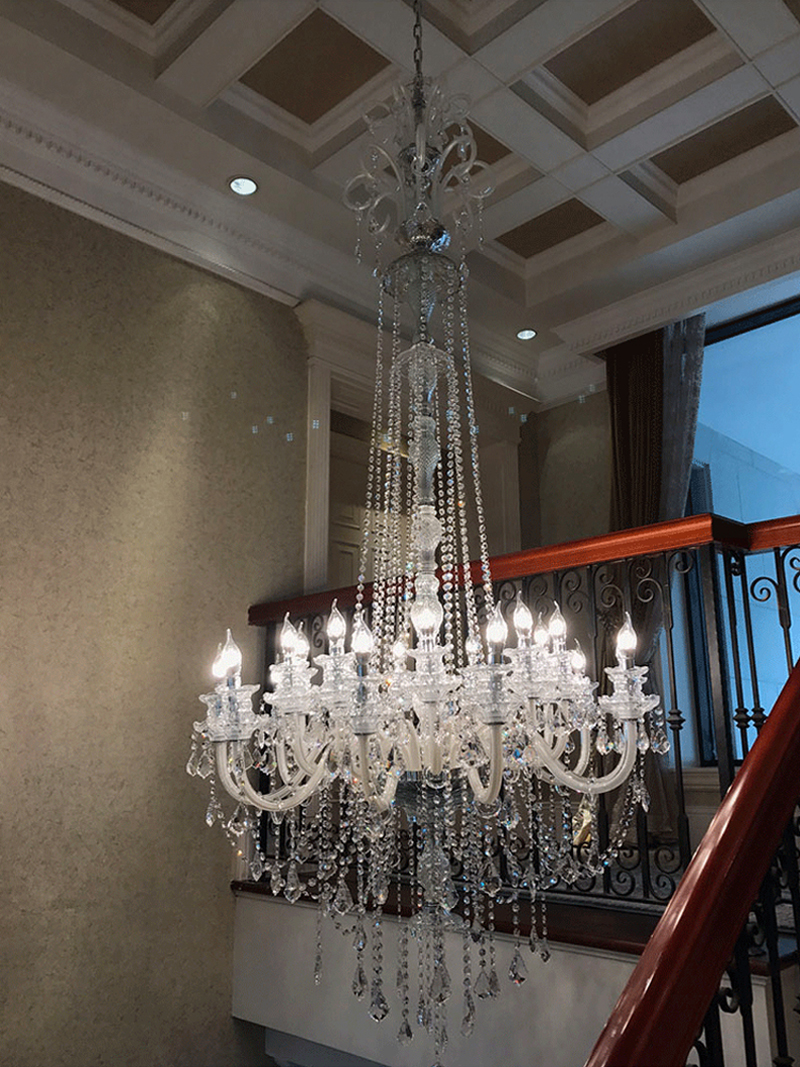 New elegant large chandeliers for high-ceiling living rooms, featuring modern chrome spiral pendant lamps with luxury crystal accents
