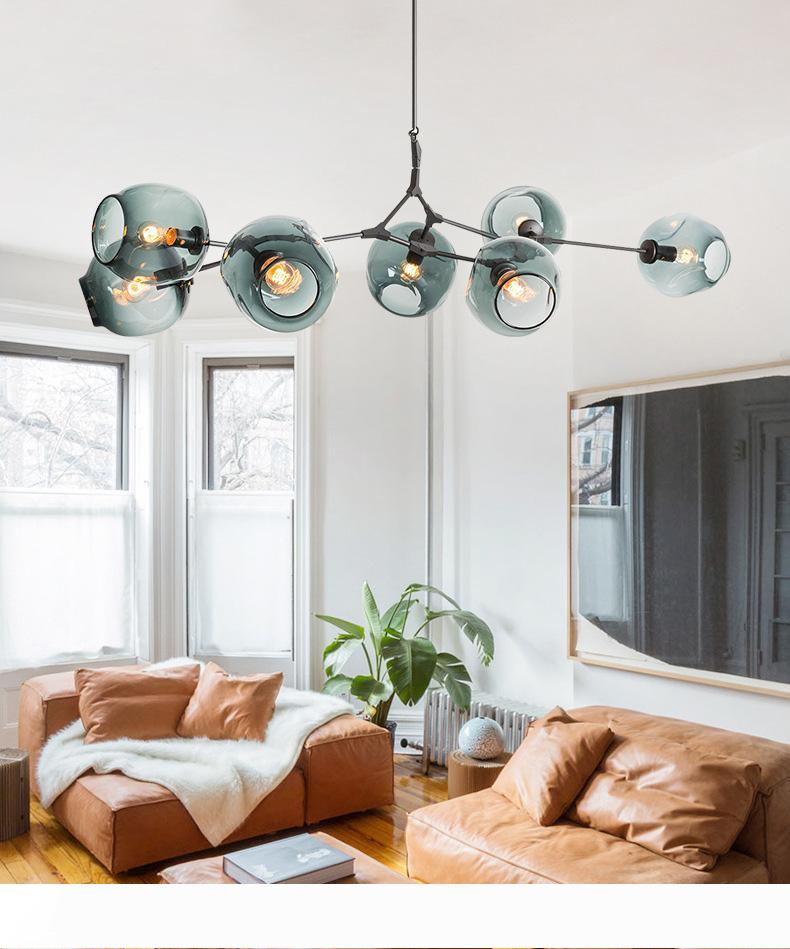 Nordic-inspired LED glass pendant lamps by Lindsey Adelman, featuring a chandelier design perfect for kitchens, with a magical beans and tree branch suspension for stylish indoor lighting fixtures