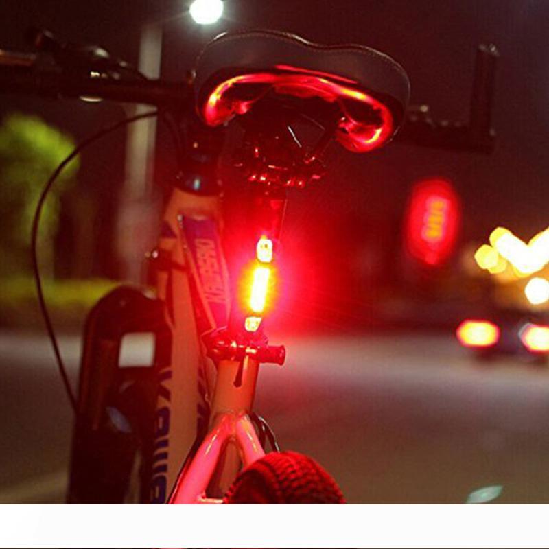 Portable USB-rechargeable bike tail light with safety warning in white, red, and blue LED