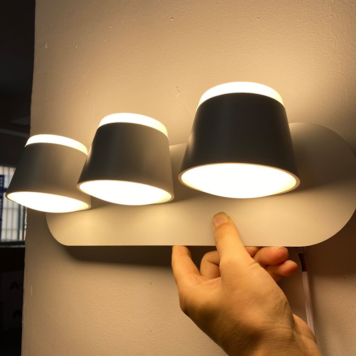 Rotating LED wall lamp for bedroom or bedside, modern mounted luminaire with 360-degree rotation, available in 8W/16W and black or white, ideal for hotel decor