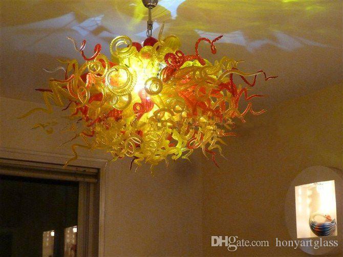 Round table centerpieces featuring orange Murano glass chandeliers, entirely handcrafted with LED lighting