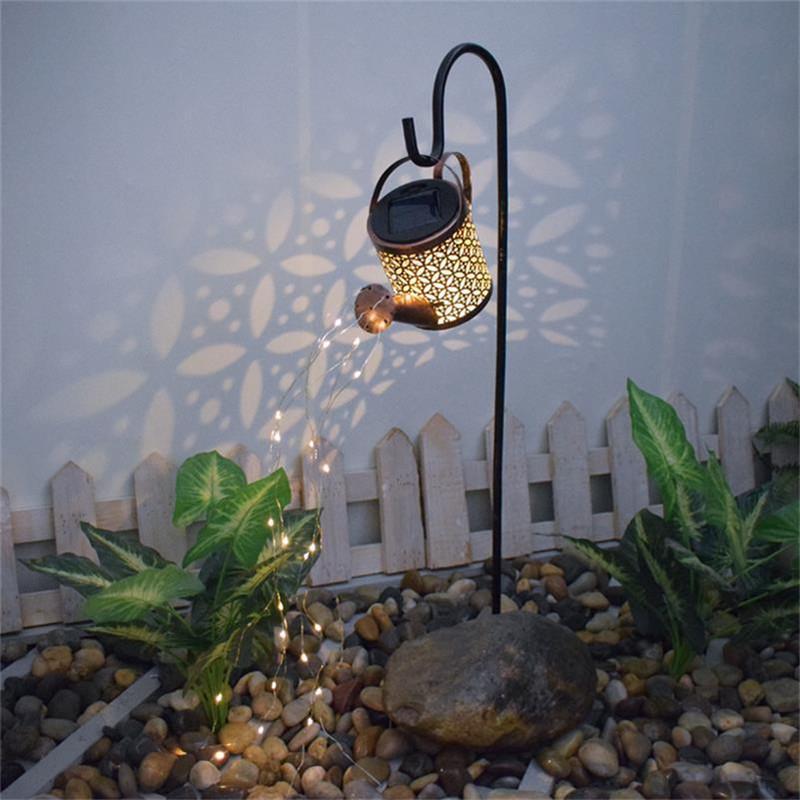 Solar-powered lawn lamps in creative iron kettle designs for outdoor garden and landscape lighting during holidays
