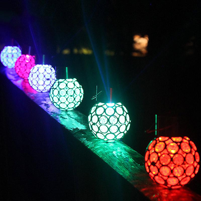 Solar-powered LED hanging lantern with hollow design for outdoor garden and patio use
