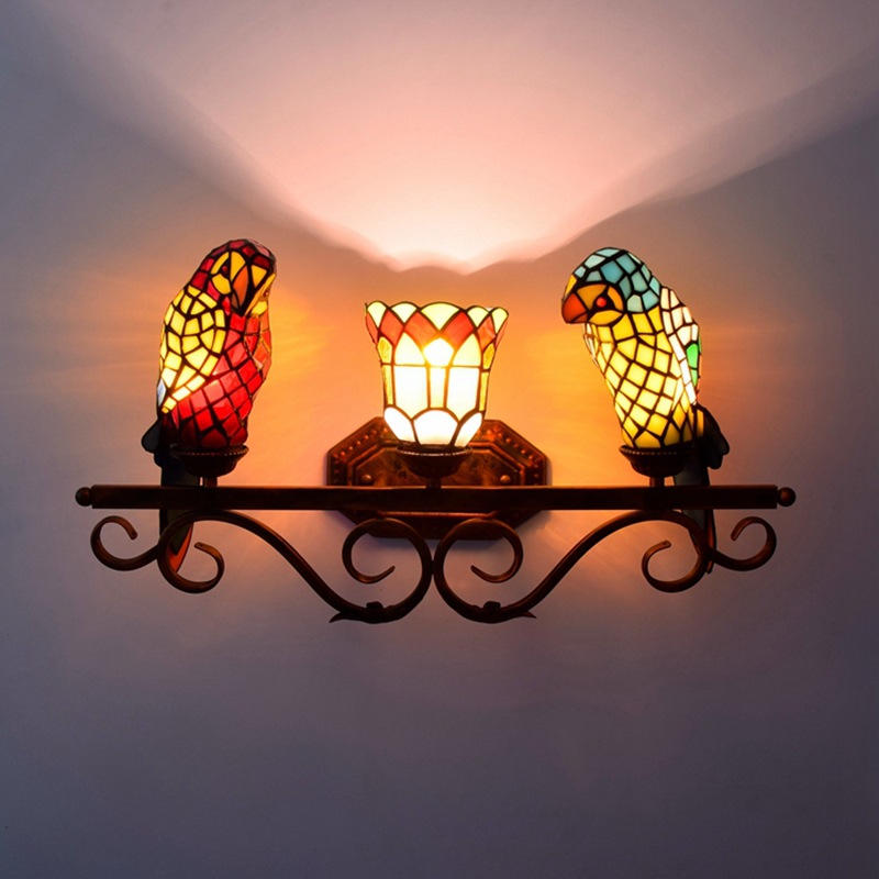 Stained glass wall lamp featuring a parrot design, ideal for living rooms, bedrooms, or kitchens with a European retro style and yellow fairy light ambiance