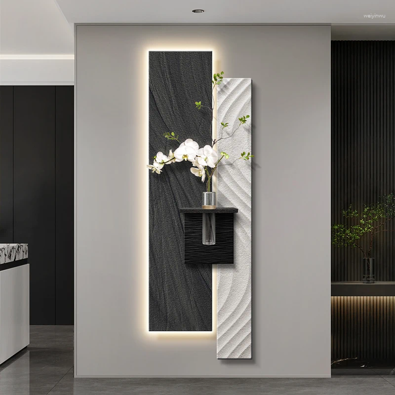 Wall-mounted stone lamps illuminate the corridor's end with abstract art and advanced ambiance