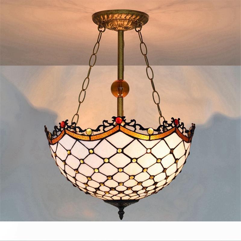 White vintage Tiffany stained glass Mediterranean lamp in living room or bar